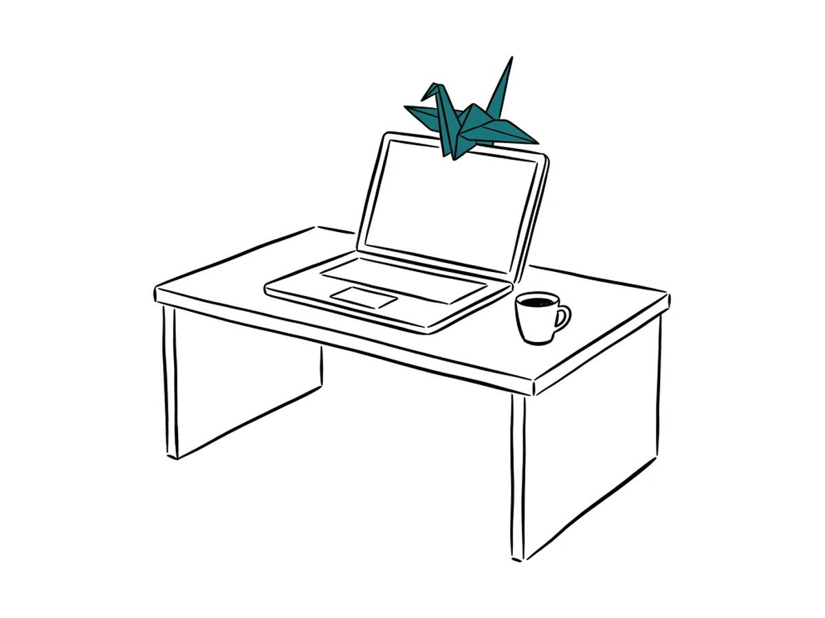 An ink drawing of a desk with an open laptop and a coffee cup; a teal origami crane is perched on the screen.